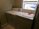 Bright laundry room featuring a white washer and dryer next to a window at , Plainfield, IN 46168