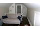 Attic sitting room with a comfortable couch, pillows, and view of the hall at , Plainfield, IN 46168