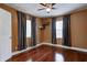 Cozy bedroom with hardwood floors, ceiling fan, and windows with blinds at 4244 Rookwood Ave, Indianapolis, IN 46208
