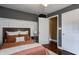 Cozy bedroom with wood headboard, stylish linens, dark accent wall, and white wainscoting detail at 4244 Rookwood Ave, Indianapolis, IN 46208