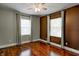 Bedroom featuring hardwood flooring, two windows, neutral paint, and a ceiling fan at 4244 Rookwood Ave, Indianapolis, IN 46208