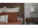 Close up of bedroom with modern nightstand, decorative lamp, and orange striped pillows at 4244 Rookwood Ave, Indianapolis, IN 46208