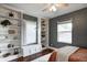 Bedroom featuring built-in bookshelves, a window seat, a ceiling fan, and neutral paint at 4244 Rookwood Ave, Indianapolis, IN 46208