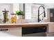 Bright kitchen features a large window above a farmhouse sink with modern faucet at 4244 Rookwood Ave, Indianapolis, IN 46208