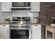 Modern kitchen features a stainless steel range and white subway tile backsplash, complemented by butcher block countertops at 4244 Rookwood Ave, Indianapolis, IN 46208