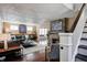 Spacious living room with stone fireplace and stairs, filled with natural light at 4244 Rookwood Ave, Indianapolis, IN 46208