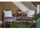 Cozy sitting area with two chairs near the staircase and beautiful hardwood floors at 4244 Rookwood Ave, Indianapolis, IN 46208