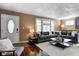 Inviting living room featuring a comfortable gray sectional sofa and ample natural light at 4244 Rookwood Ave, Indianapolis, IN 46208
