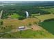 Discover the serene setting of lush greenery surrounding the lake, as seen from an aerial view of the property at 4363 E State Road 252, Franklin, IN 46131