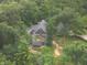 Expansive gray home surrounded by mature trees and lush greenery in a peaceful, wooded setting at 4363 E State Road 252, Franklin, IN 46131