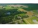 Expansive aerial view capturing the estate's lush landscaping, serene lake, and verdant surroundings at 4363 E State Road 252, Franklin, IN 46131