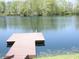 Lake view featuring a wooden dock with stairs offering access to the water for swimming or boating activities at 4363 E State Road 252, Franklin, IN 46131