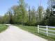 Admire the expansive lawn and private driveway, framed by lush greenery, enhancing the property's curb appeal at 4363 E State Road 252, Franklin, IN 46131