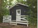 Charming cabin with dark wood siding and a white decorative porch railing at 4363 E State Road 252, Franklin, IN 46131