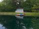 Exterior view of a property by the lake, featuring a dock and pedal boats adding to the recreational appeal at 4363 E State Road 252, Franklin, IN 46131