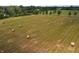 Expansive field with neatly arranged hay bales, perfect for agricultural use or enjoying the open countryside at 4363 E State Road 252, Franklin, IN 46131