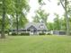 Charming gray home with a welcoming front porch, lush lawn, and mature trees creating a serene setting at 4363 E State Road 252, Franklin, IN 46131