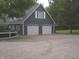 Spacious two-car garage with white doors, ample parking, and a neatly paved driveway at 4363 E State Road 252, Franklin, IN 46131