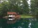Lakeside deck with a boat and a scenic backdrop, showcasing a peaceful and private retreat at 4363 E State Road 252, Franklin, IN 46131