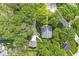 An aerial view of a house with mature trees and a detached garage surrounded by lush greenery at 440 W Marion St, Danville, IN 46122