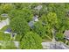 Aerial view showcasing a home with a gray roof surrounded by large mature trees at 440 W Marion St, Danville, IN 46122