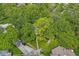 Overhead view of a home surrounded by mature trees and manicured lawns at 440 W Marion St, Danville, IN 46122
