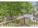 Backyard view from wood deck featuring mature trees and a quaint garage at 440 W Marion St, Danville, IN 46122