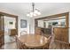 Bright dining room featuring a wooden table set, lighting fixture, and view into the adjacent living room and kitchen at 440 W Marion St, Danville, IN 46122