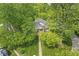 Charming home's exterior is surrounded by lush trees with a long grassy front lawn at 440 W Marion St, Danville, IN 46122