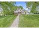 Beautifully landscaped yard with a charming home, long driveway, and garage at 440 W Marion St, Danville, IN 46122
