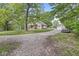 Exterior view of home, driveway, and garage with mature trees at 440 W Marion St, Danville, IN 46122