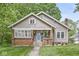 Charming home featuring a brick and siding facade, a blue door, and a welcoming front porch at 440 W Marion St, Danville, IN 46122