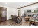 Cozy living room featuring a brick fireplace, wood flooring, comfortable seating, and exposed wood beams at 440 W Marion St, Danville, IN 46122