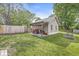 Backyard shed with double doors and gravel foundation, accompanied by a well-maintained lawn at 440 W Marion St, Danville, IN 46122