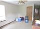 A spacious bedroom with a ceiling fan and natural light, awaiting a refresh at 470 N Pine St, Morgantown, IN 46160