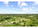 Expansive aerial view of a sprawling property featuring a home, barn, and lush green pastures at 4749 Maple Grove Rd, Martinsville, IN 46151