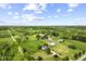 Scenic aerial view showcases a charming home nestled amongst green pastures and mature trees at 4749 Maple Grove Rd, Martinsville, IN 46151