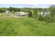 Aerial view of charming property featuring a house, barn, horse, and expansive green pasture at 4749 Maple Grove Rd, Martinsville, IN 46151