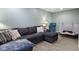 Basement with sectional couch, neutral pillows, blanket, and trampoline at 4749 Maple Grove Rd, Martinsville, IN 46151