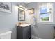 Stylish powder room with gray vanity, modern fixtures, and decorative accents at 4749 Maple Grove Rd, Martinsville, IN 46151