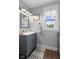 Elegant bathroom featuring gray vanity, updated lighting, and neutral color palette at 4749 Maple Grove Rd, Martinsville, IN 46151