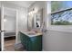 Bathroom showcasing a double vanity with painted cabinets and rustic framed mirrors at 4749 Maple Grove Rd, Martinsville, IN 46151