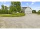 The home boasts a garage and ample parking space with a gravel driveway at 4749 Maple Grove Rd, Martinsville, IN 46151