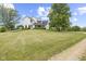 Beautiful two-story home showcasing a spacious green lawn, and mature trees at 4749 Maple Grove Rd, Martinsville, IN 46151