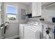 Clean laundry room with a window offering a view and modern washer and dryer at 4749 Maple Grove Rd, Martinsville, IN 46151