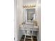 A vanity area with white chair and mirror with natural lighting is shown at 4749 Maple Grove Rd, Martinsville, IN 46151