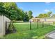 Fenced backyard with mature trees offers privacy and space at 48 W Adams Brick Ave, Martinsville, IN 46151