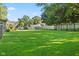 Large, grassy backyard enclosed with wood and chain link fences at 48 W Adams Brick Ave, Martinsville, IN 46151
