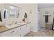 Functional bathroom with double sinks, good counter space, a shower-tub combination, and wood-look flooring at 48 W Adams Brick Ave, Martinsville, IN 46151