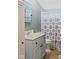 Bathroom with blue vanity, blue patterned shower curtain, and gray walls at 48 W Adams Brick Ave, Martinsville, IN 46151